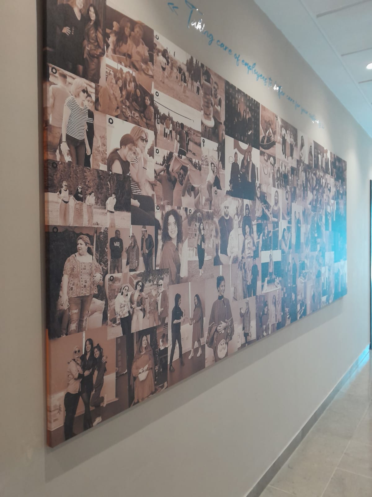 Wall of PolyCall employee portraits